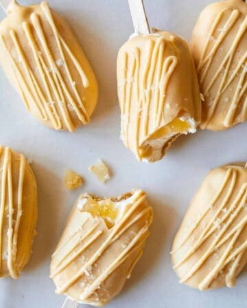 A close up of salted butterscotch apple pie cheesecake bars with bites taken out.