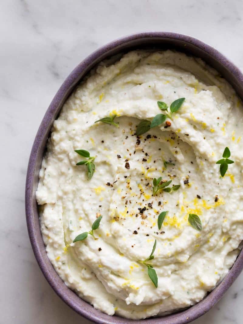 A close up of a bowl of black pepper and lemon asiago dip.