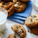 A close up of salted brown butter chocolate chips cookies and milk.