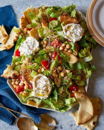 Fattoush style salad with crispy quinoa on a platter.