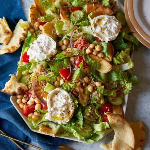 Fattoush style salad with crispy quinoa on a platter.