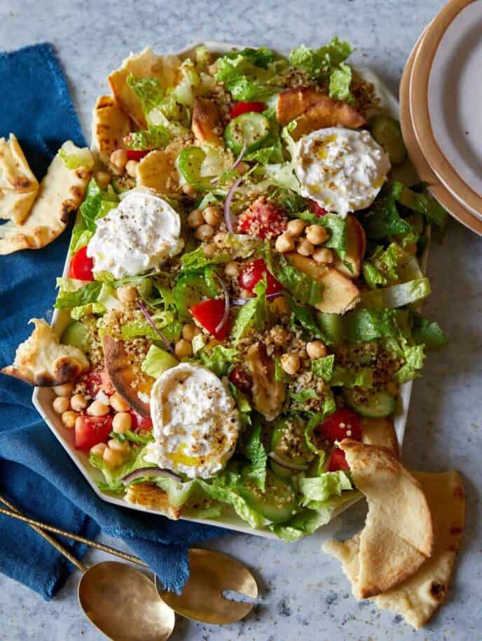 Fattoush style salad with crispy quinoa on a platter.