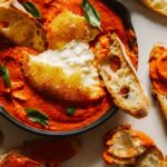 Fried burrata over romesco sauce with bread.