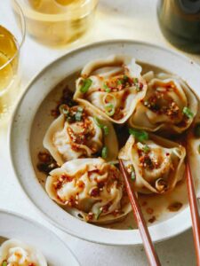 Pork and shrimp dumplings with chopsticks.