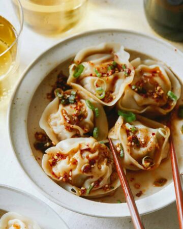 Pork and shrimp dumplings with chopsticks.