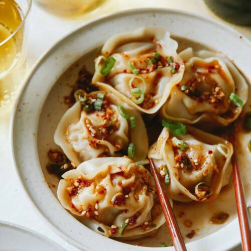 Pork and shrimp dumplings with chopsticks.