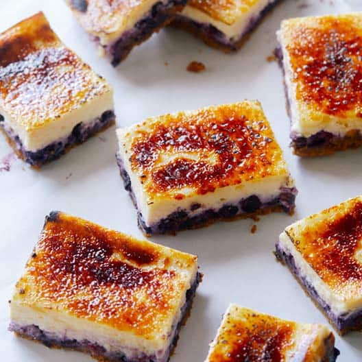 Blueberry Cheesecake Crème Brûlée bars cut up on a platter.