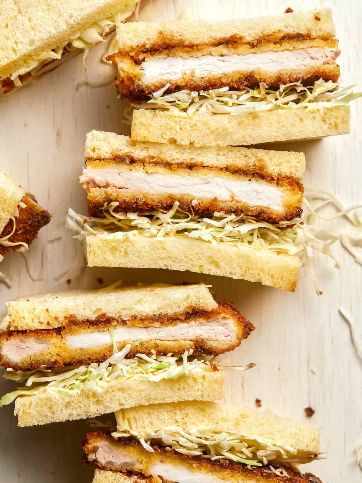 A close up of pork katsu sandwiches cut in half.
