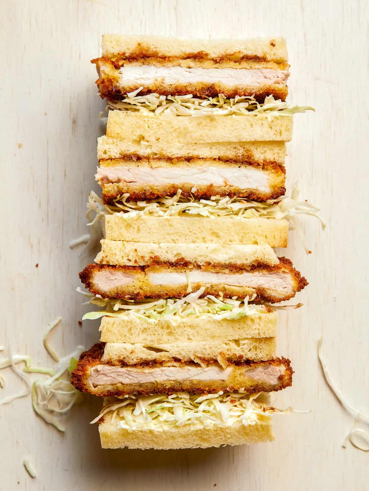 Stacked pork katsu sandwiches cut in half.