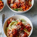 Bowls of turkey bolognese with spaghetti and zucchini noodles.