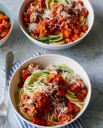 Bowls of turkey bolognese with spaghetti and zucchini noodles.