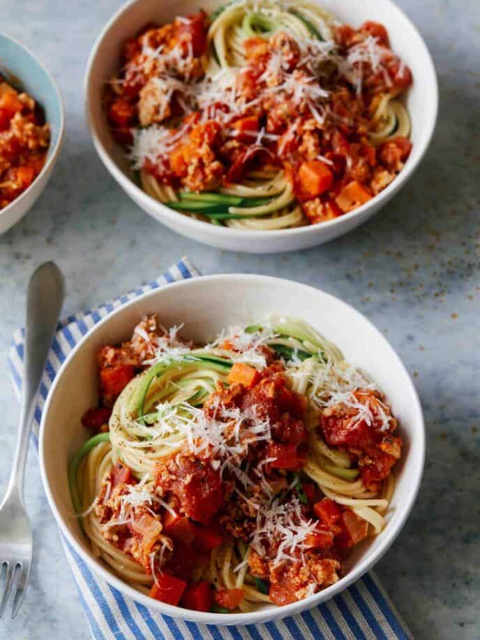 Bowls of turkey bolognese with spaghetti and zucchini noodles.