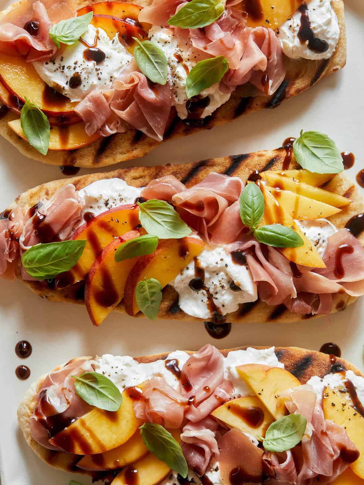 Grilled Flatbreads Topped with Peach, Prosciutto and Burrata-image