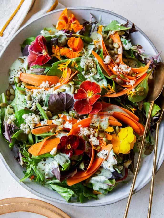 A summer salad with green goddess dressing and spoons, an Easter dinner salad.  