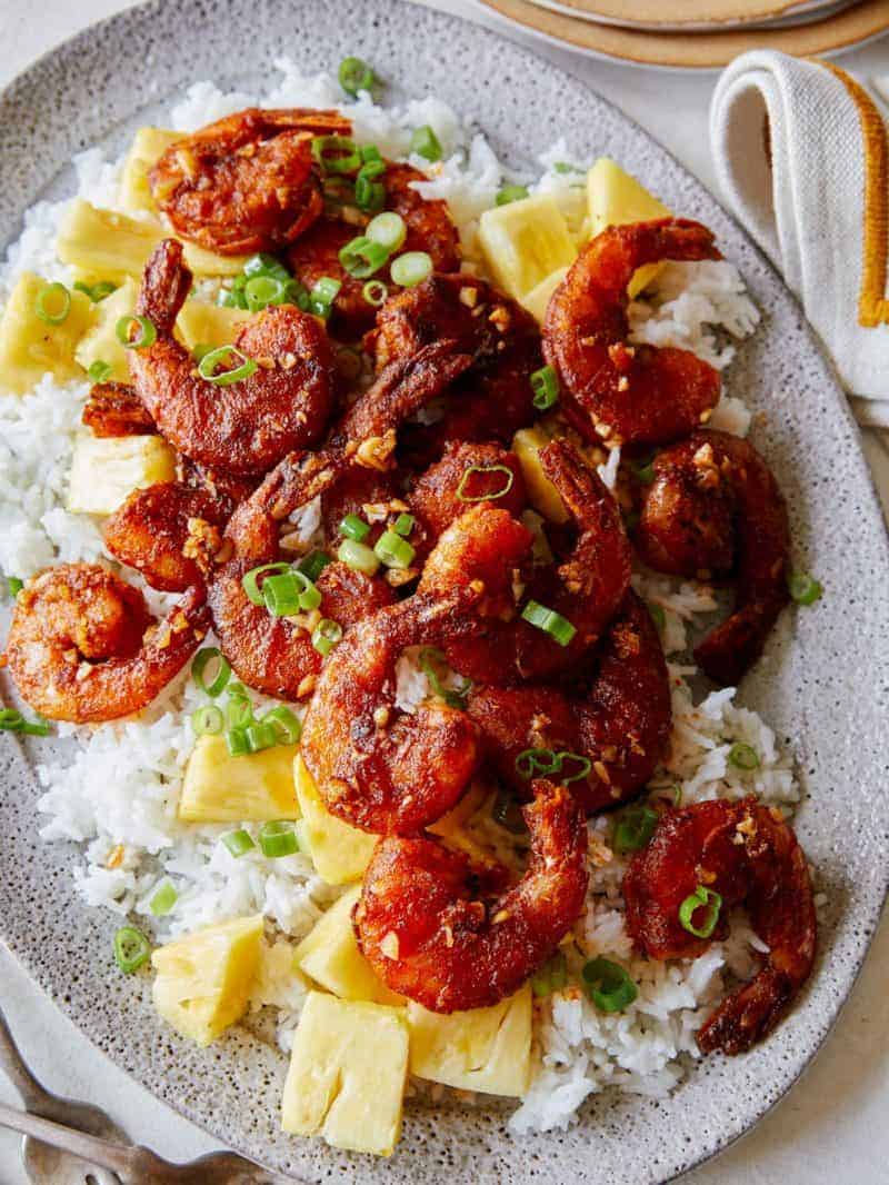 Hawaiian style crispy shrimp on a platter with rice. 