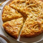 Cacio e pepe pasta pie with slices cut.