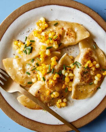 Creamy shrimp and corn ravioli on a plate with a fork.