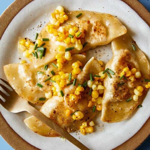 Creamy shrimp and corn ravioli on a plate with a fork.