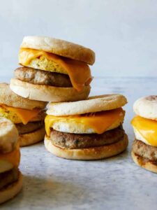 Stacked turkey sausage, egg and cheese breakfast sandwiches.