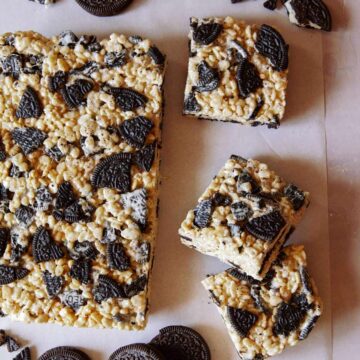 A sheet of cookies and cream Rice Krispies Treats with some squares cut off.
