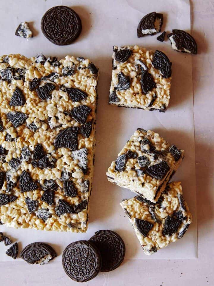 A sheet of cookies and cream Rice Krispies Treats with some squares cut off.
