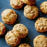 Ham and cheese buttermilk biscuits on a blue background.