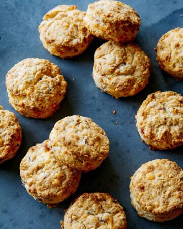 Ham and cheese buttermilk biscuits on a blue background.