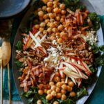 Platter of chicken kale apple and goat cheese salad.