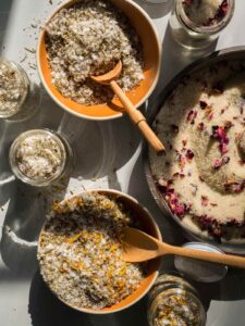 Several bowls of different salt mixes with wooden spoons.