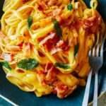 A close up of dairy free creamy butternut squash pasta with a fork.