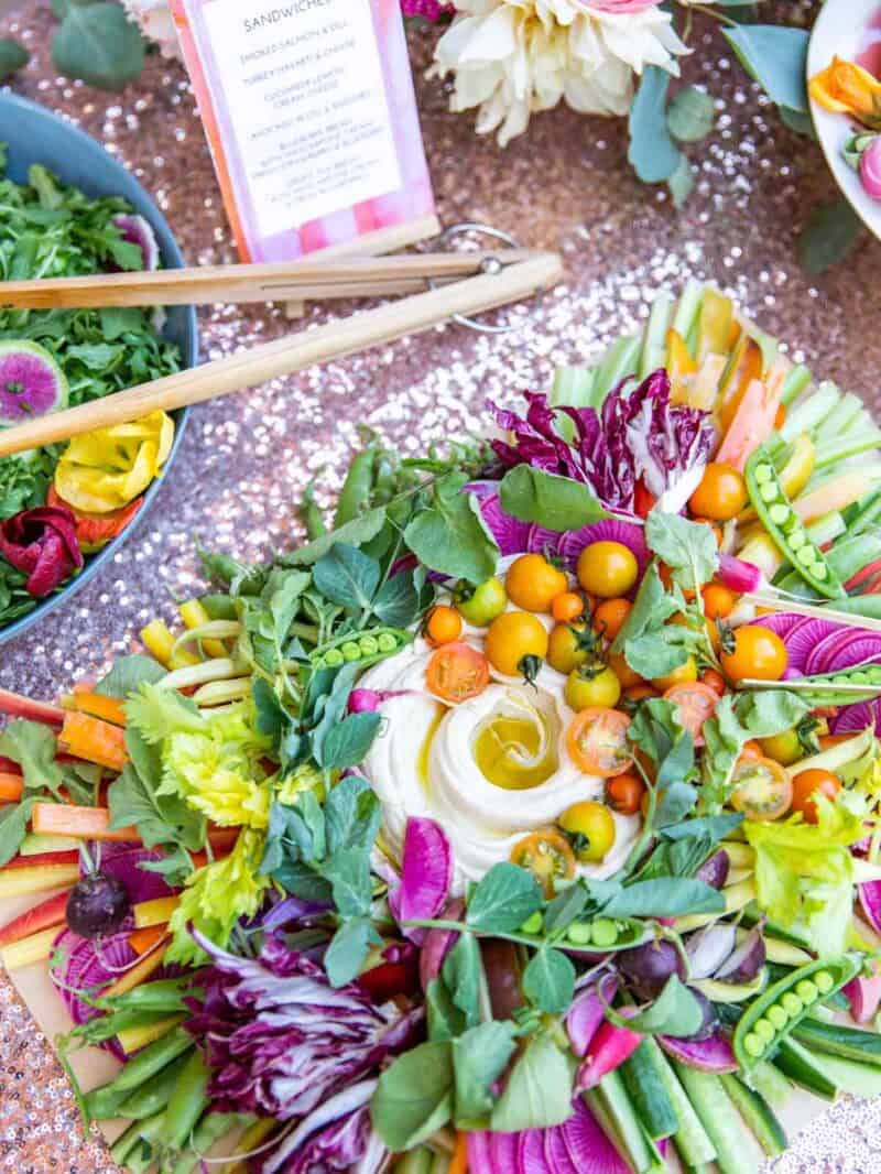 A large vegetable platter with a salad and tongs.