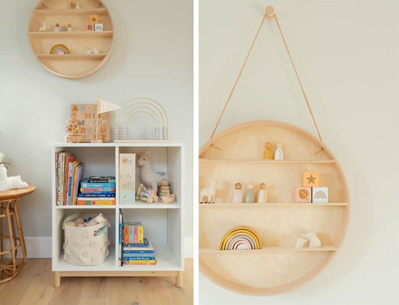 Nursery wall decor and book shelves filled with toys and books.