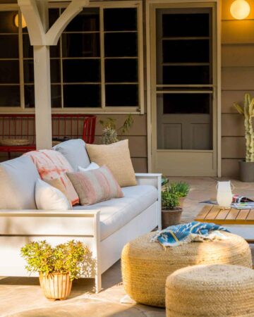 A furnished patio with a couch and table.