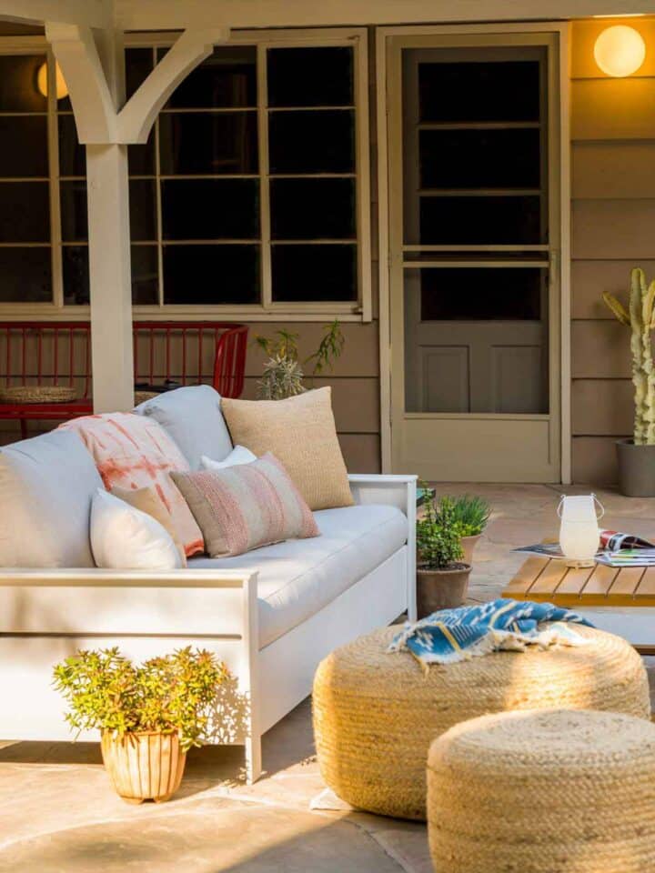 A furnished patio with a couch and table.