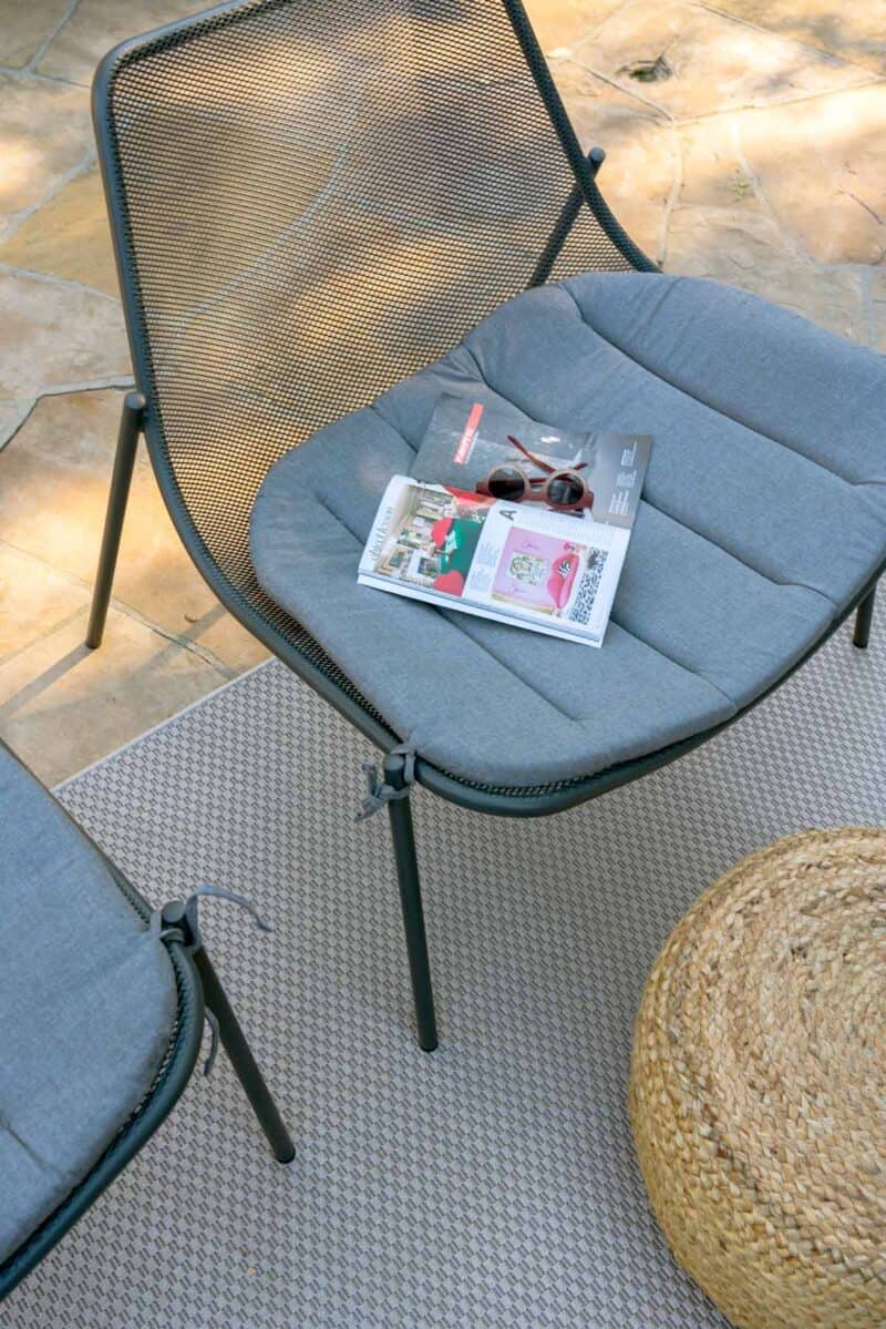 Top view of a patio chair with a cushion.