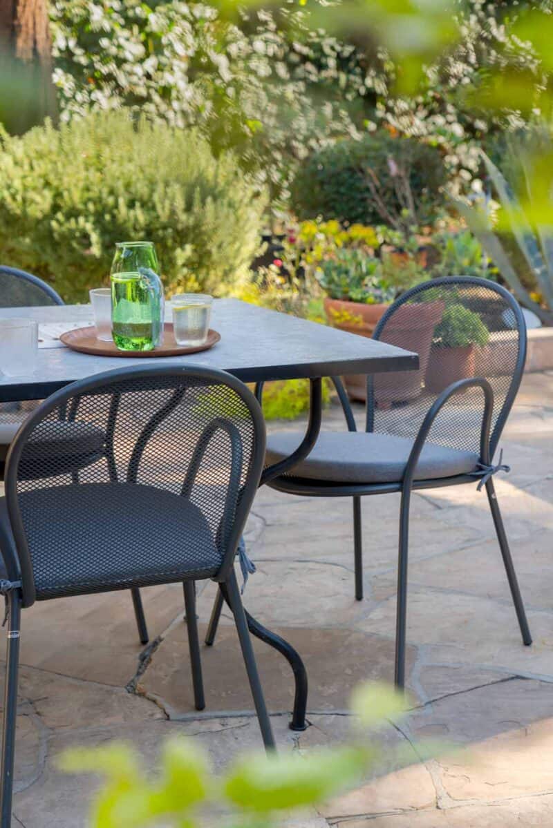 Outdoor dining table and chairs and drinks.