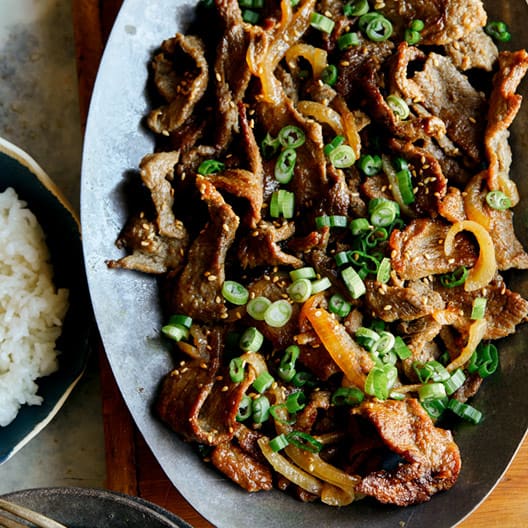 Korean beef bulgogi on a platter with a side of white rice.