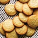 Pile of chewy lemon cookies on black and white plate.