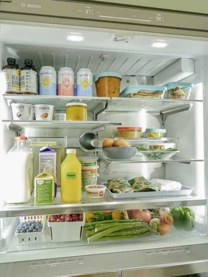 The inside of a refrigerator filled with food and drinks.