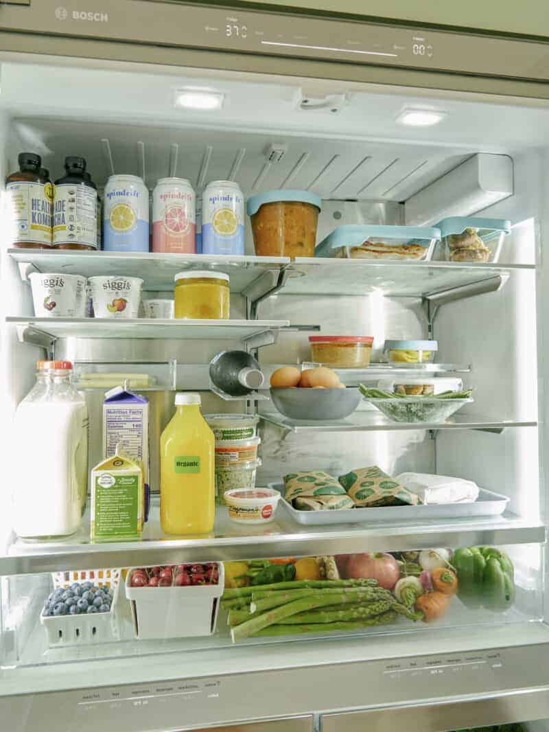 The inside of a refrigerator filled with food and drinks.