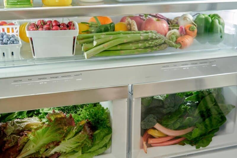 Refrigerator drawers full of fruits and vegetables.