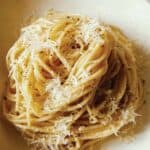 A close up of a swirled pile of cacio e pepe.