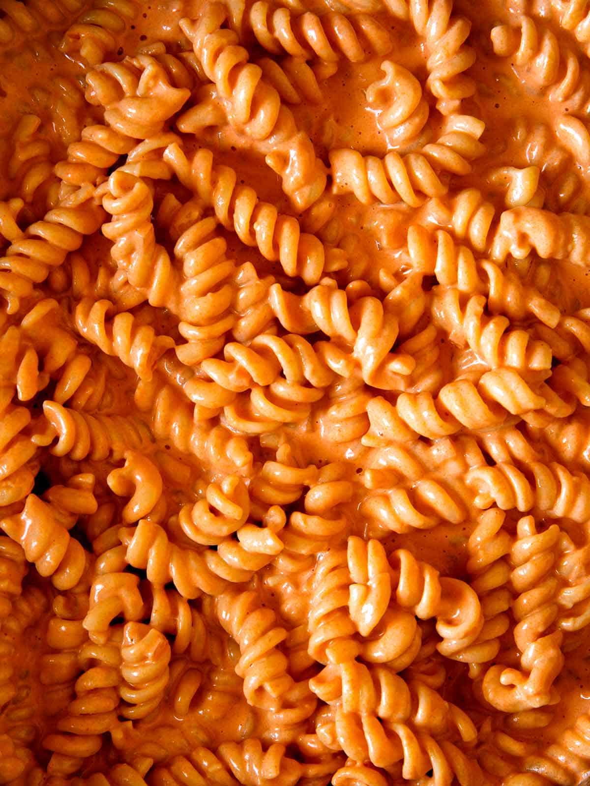 Glossy vodka sauce up close with pasta.