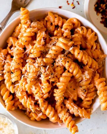 A close up of a bowl of fusilli pasta with vodka sauce.