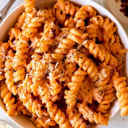A close up of a bowl of fusilli pasta with vodka sauce.