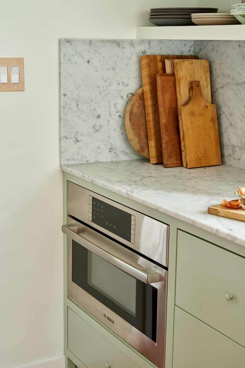 Inset Bosch speed oven with cutting boards on the counter above.