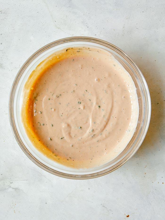 Combined ingredients in a bowl to make BBQ Yogurt Ranch Dressing.