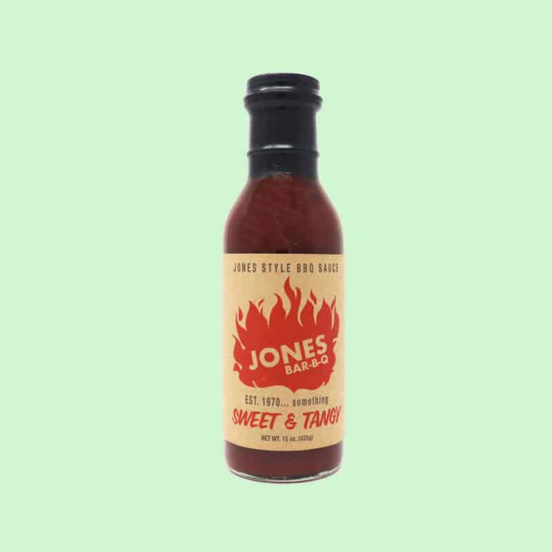 A bottle of Jones Bar BBQ sauce on a green background.