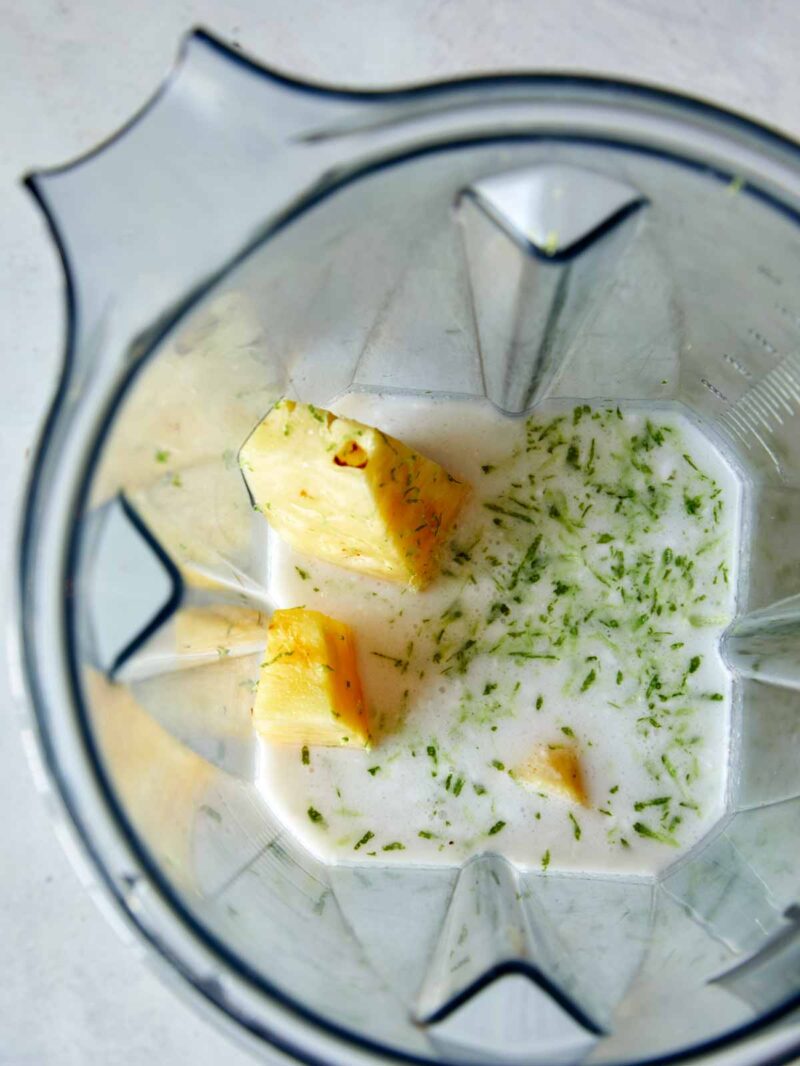 Ingredients for our piña colada ice pops in a blender ready to be blended. 