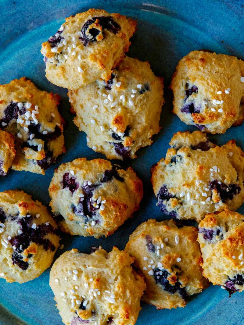 A close up of blueberry yogurt cookies on a blue plate.